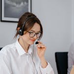 A Woman Wearing a Headset while Working on a Laptop